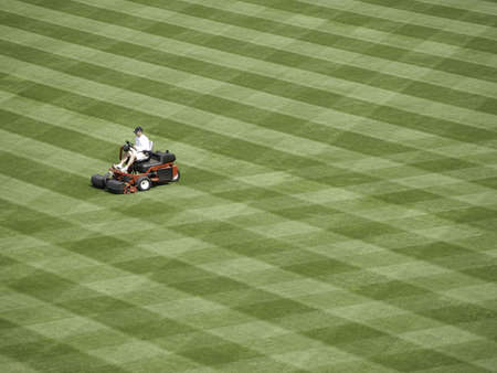 Workman readies a baseball field for the season.の写真素材