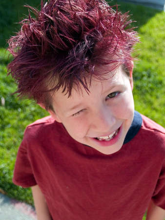 Little boy with crazy hair winks at the cameraの写真素材