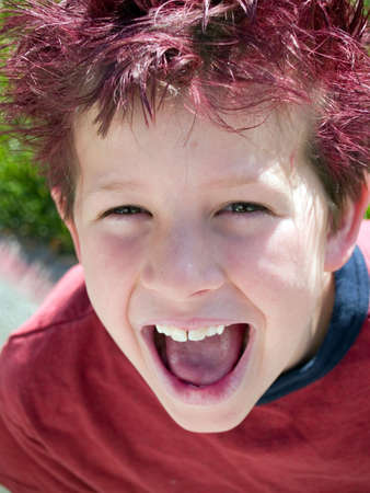Little boy with crazy hair winks at the cameraの写真素材