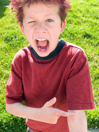 Little boy with crazy hair winks at the cameraの写真素材