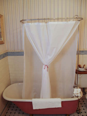 Antique bath tub with a shower linerの写真素材