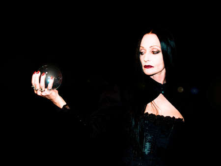 Crystal ball held in the hands of a fortune teller.の写真素材