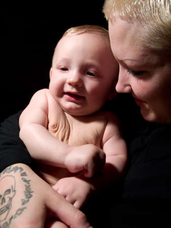 A very cute little infant sitting outsideの写真素材