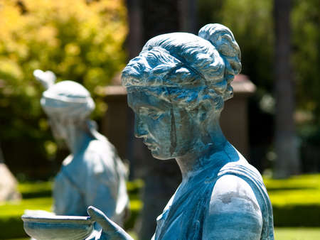 Bronze statues in a garden, both woman and manの写真素材