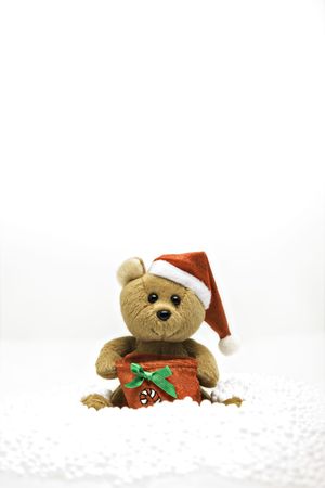 small teddybear sat in the snow, christmas decorationの写真素材