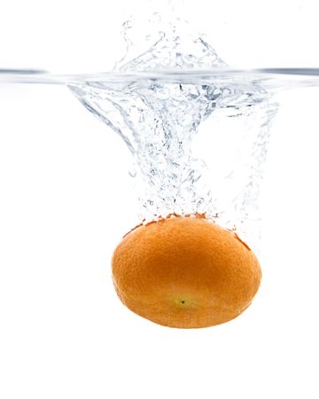 Fresh Tangerine splashing into water with white backgroundの写真素材