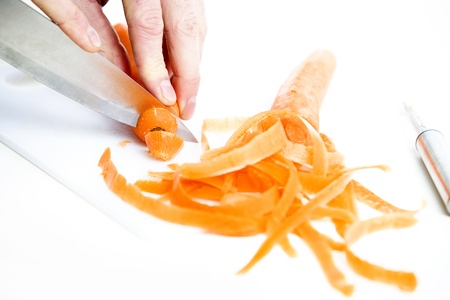 orange carrot been slided and diced in a kitchenの写真素材
