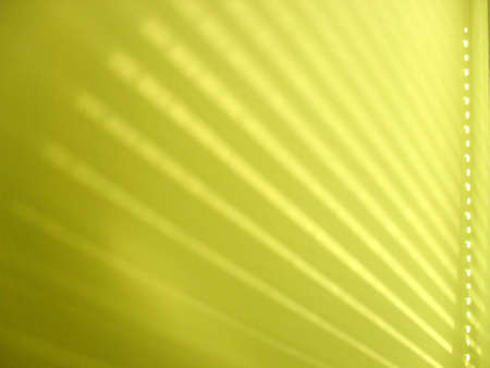 Shadow of venetian blinds on yellow wallの写真素材