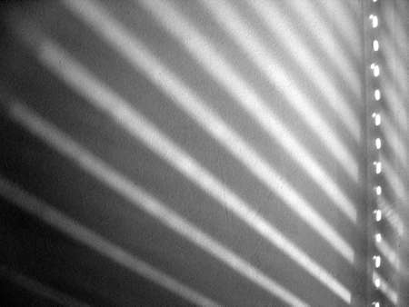Shadow of venetian blinds on wall in black and whiteの写真素材