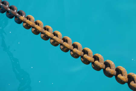 OLD CHAIN ON TURQUOISE WATER