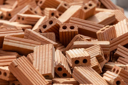 A close up of orange bricks mason We are building the walls of the house, designing the arrangement of bricks to create the wallsの写真素材