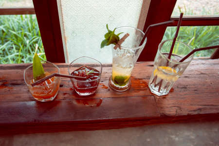 Close up the lemonade drink with ice in a clear glass beside a glass tube and the laboratory, adjust the flavor to the right, drink it, and refresh it, make it a refreshing drink in Summerの写真素材