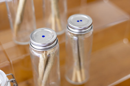 Medical science research laboratory with cannabis plant stem specimen in clear glass jar container. This concept shows focus on botany and alternative therapy