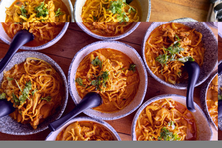 Authentic spicy thai coconut curry noodle soup served in rustic bowl on wooden table top view showing appetizing crispy yellow garnish offering inviting warm cultural culinary experience
