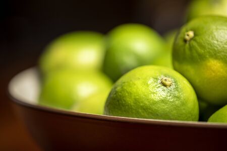 Close up of ripe green limes in a bowl
