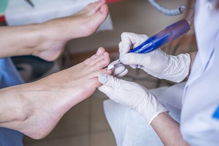 Professional pedicure master making pedicure in salonの写真素材