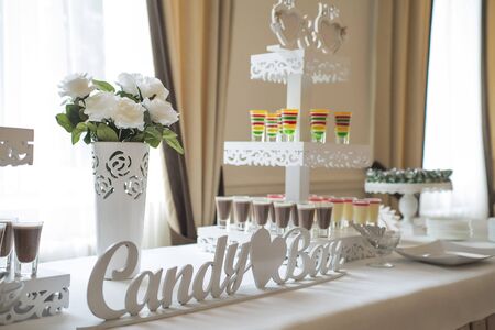 stylish luxury decorated candy bar for the celebration of a wedding of happy couple, cathering in the restaurantの写真素材