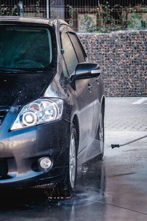 the guy washes the car himself during coronavirusの写真素材