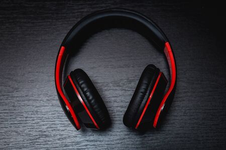 Red wireless headphone on black background
