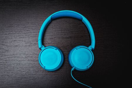 3D surround photo blue wireless headphones on black background.