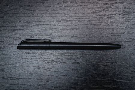 black office pen lies on a black backgroundの写真素材