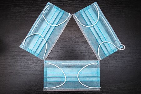 blue medical masks on a black background