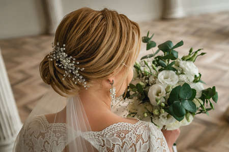 Brides morning. Fine art wedding. Beautiful jewelry on the brides hairstyle on the wedding dayの写真素材