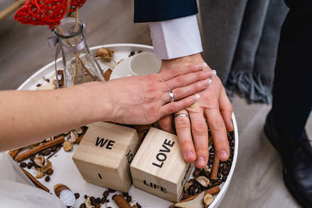 Hands of the newly weds. with the inscription love.の写真素材