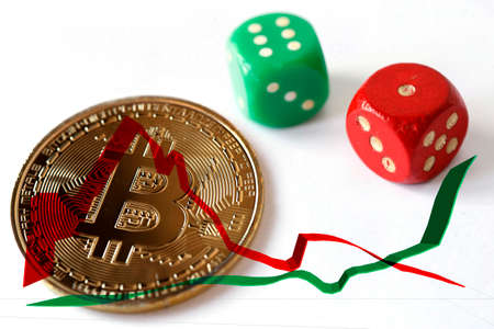 A red and green dice, a cryptocurrency coin in combination with positive and negative trend-linesの写真素材