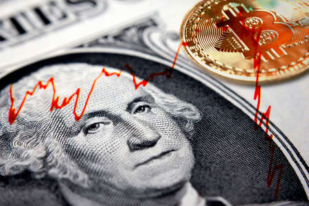 Cryptocurrency coin on top of a US dollar bill