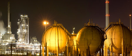 A large oil-refinery plant with Liquefied Natural Gas - LNG - storage tanks