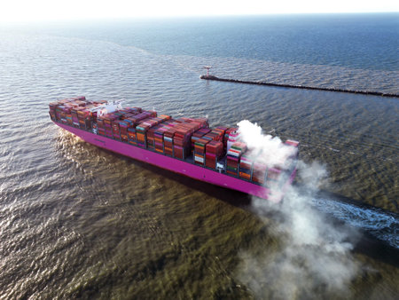 A large containership leaving the harbour and entering the open sea