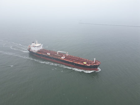 A large oil tanker approaching the port of Rotterdam in misty conditionsの写真素材