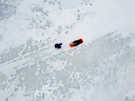 Hiking on a frozen lake and using a pulka for carrying supplies