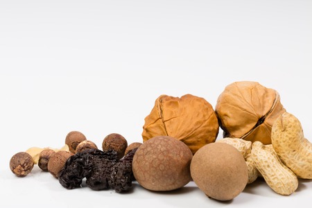 A pile of mixed nuts in white backgroudの写真素材