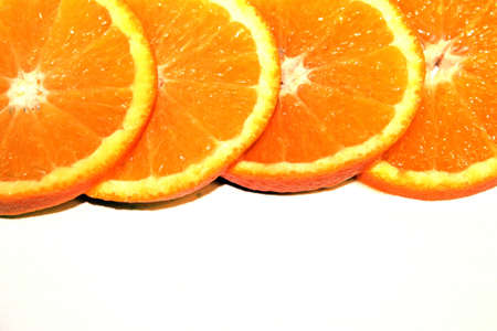 Orange Pieces On White Colored Backgroundの写真素材