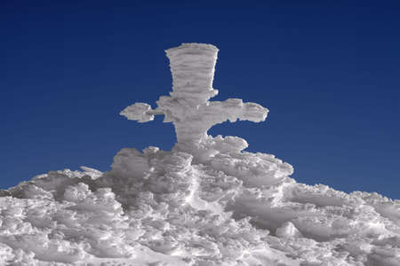 Gore's cross at Omu Peak 2500m , Bucegi Mountains, Carpathians, Romania, covered with hoar-frost.の写真素材