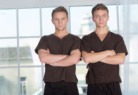 Professional massage medical treatment. Portrait of two professional physiotherapist masters of massage. Massage spa healthy medical conceptの写真素材