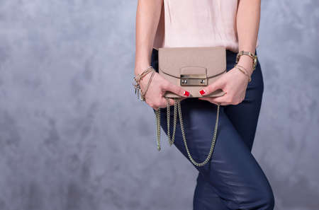 Bags fashion trends. Close up of gorgeous stylish bag. Fashionable woman is holding a trendy bag....