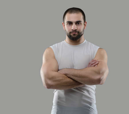 Great workout. Portrait of muscular professional bodybuilder and fitness trainer. Muscular male sportsman is training himself. Gym fitness sport muscle concept.の写真素材