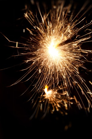 Burning Bengal fire on a black background. Christmas, New Year sparkle fire. Festive background,...