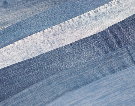 stack of various shades of jeans as backgroundの写真素材