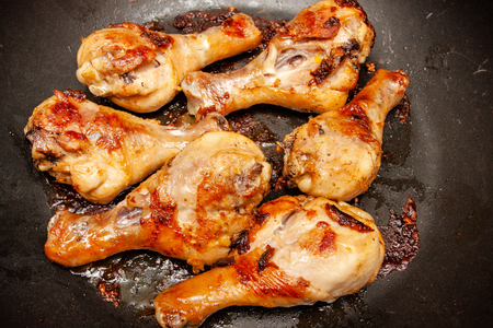Roasted chicken legs on the black background.の写真素材