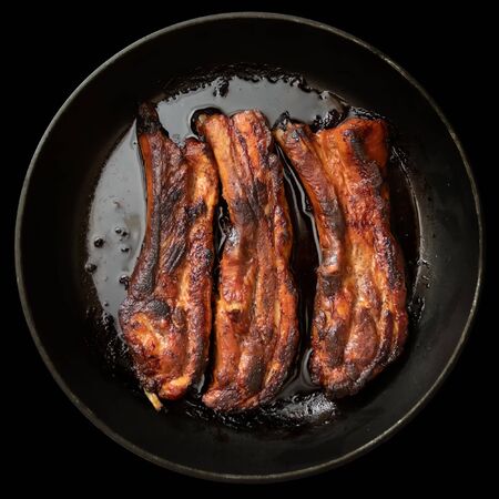 Juicy fried pork ribs in a panの写真素材