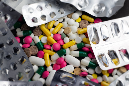 Various medical drugs, antibiotics and vitamins are scattered on the table.の写真素材