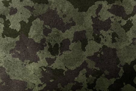 Texture of military dirty camouflage fabric. Combat protective camouflage for backgroundの写真素材