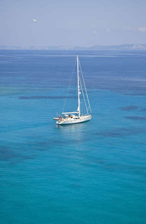 white sailing boat on turquoise ionian seaの写真素材