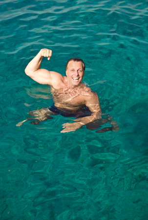 happy laughing man posing in the waterの写真素材