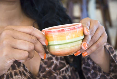 Woman holding coffee cupの写真素材