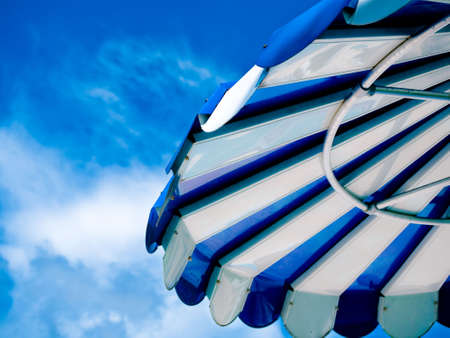 Relaxing outdoors under umbrella at the beachの写真素材